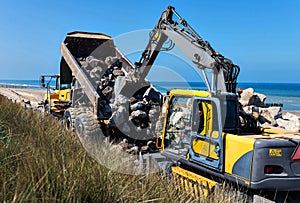 large hydraulic excavators working as a team on a construction site