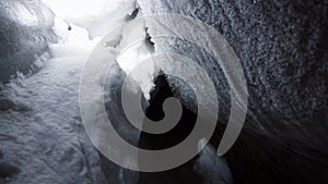 A large ice cave covered with white snow.