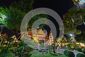 Large illuminated temple Wat Arun after sunset seen accross river Chao Phraya Bangkok