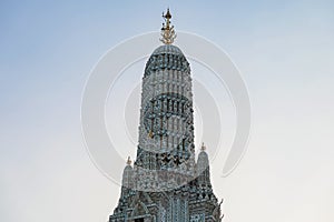 Large illuminated temple Wat Arun after sunset seen accross river Chao Phraya Bangkok