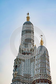 Large illuminated temple Wat Arun after sunset seen accross river Chao Phraya Bangkok