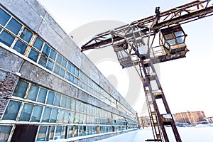 Large industrial building in abandoned factory area with rusty lift