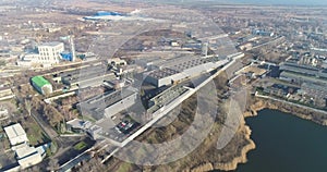 Large industrial complex top view, modern factory near the lake drone view