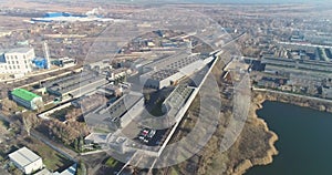 Large industrial complex top view, modern factory near the lake drone view