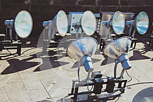 Large industrial floodlights of an industrial stadium plant on a steel pylon