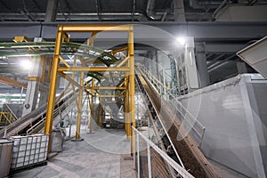 Large industrial mixer, for mixing ingredients into liquid cement.. Workers in the workshop of the House-building plant