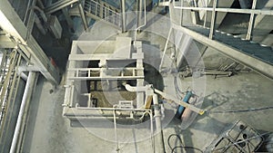 Large industrial mixer, for mixing ingredients into liquid cement.. Workers in the workshop of the House-building plant