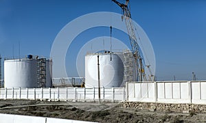 Large industrial oil tanks at the base of an oil refinery. industrial plant