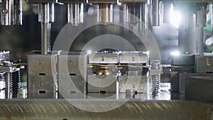 A large industrial punch press forming high precision metal parts for the automotive industry