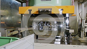 A large industrial punch press forming high precision metal parts for the automotive industry