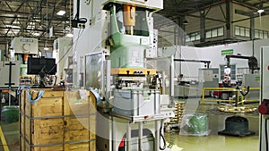 A large industrial punch press forming high precision metal parts for the automotive industry