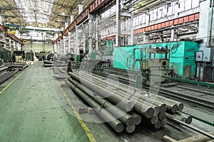 Large industrial workshop factory interior with machines, lathes and steel pipes for processing metal production