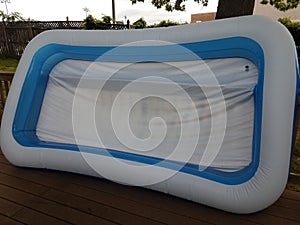 large inflatable swimming pool on wood deck outdoor