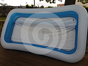 large inflatable swimming pool on wood deck outdoor