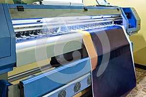 Large inkjet printer head working on blue vinyl