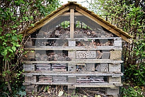 Large insect hotel in corner of garden.