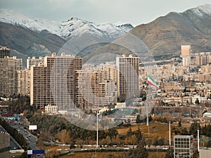 Large Iran Flag and Tehran City Skyline against Alborz Mountains with Instagram Warm Effect