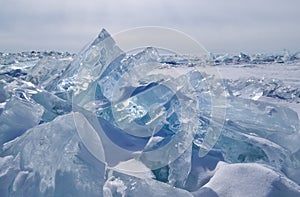 Large iridescent crystals white blue ice floes with cracks glow in the light of the sun, lake baikal