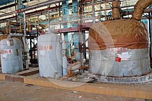 Large iron heat exchanger, tank, reactor, distillation column in thermal insulation of fiberglass and mineral wool of galvanized