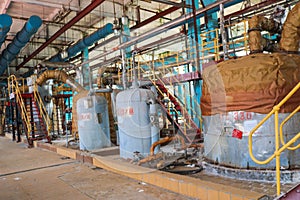 Large iron heat exchanger, tank, reactor, distillation column in thermal insulation of fiberglass and mineral wool of galvanized