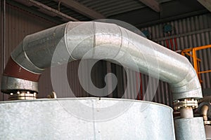 Large iron heat exchanger, tank, reactor, distillation column in thermal insulation of fiberglass and mineral wool of galvanized