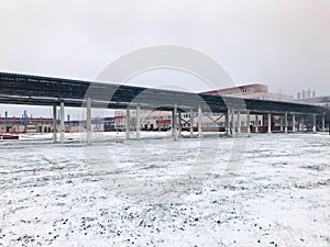 Large iron metal chemical stainless pipe rack with pipes, power equipment at the refinery, petrochemical plant in the winter