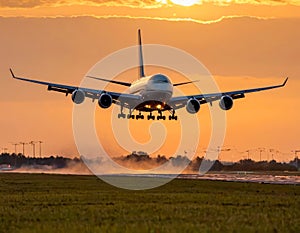 A large jet airliner takes off from an airport runway at sunset or dawn with its landing gear down.