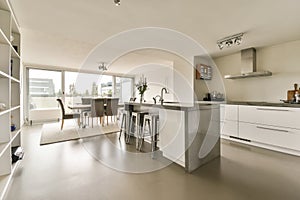 a large kitchen with an island and a dining table