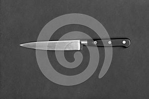 Large kitchen knife on a black background