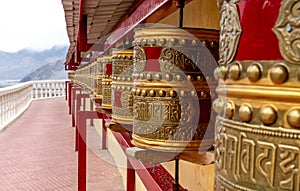 Large landmark Buddhist monastery with prayer wheels in India