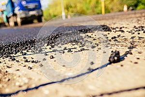 A large layer of fresh hot asphalt. Road construction. Construction of a new road