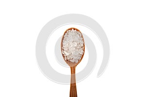 Large Lemon salt crystals in wooden spoon isolated on white background, close-up. Citric acid salt. Food additive E330. Design