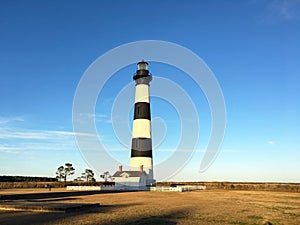 Striped lighthouse set against the blue sky