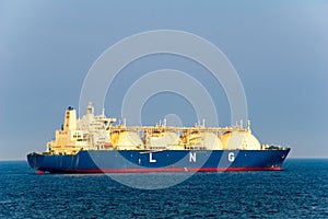 Large liquefied natural gas LNG carrier with 4 LNG tanks sails in the sea