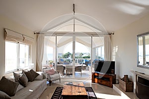 Large living room big full length glass doors leading onto an outside terrace