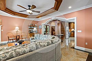 Large living room with a ceiling fan and table and chairs