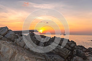 A large log was hit by the waves and stuck on the rocks