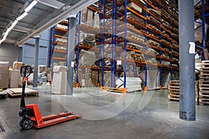 Large Logistics hangar warehouse with lots shelves or racks with pallets of goods. Industrial shipping and cargo delivery