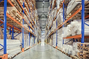 Large Logistics hangar warehouse with lots shelves or racks with pallets of goods. Industrial shipping and cargo delivery