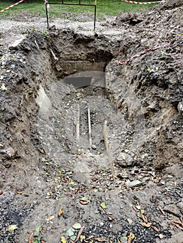 A large long pit with old pipes at the bottom during the elimination of the accident and their replacement