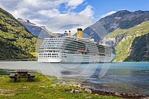 Large luxury cruise ship anchored in fjord photo