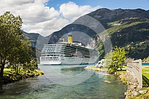Large luxury cruise ship anchored in fjord and camping cars photo