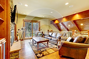 Large luxury living room with leather sofa and TV.