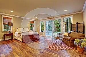 Large master bedroom wth hardwood floor.