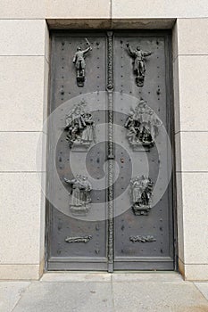 Large metal doors with plastic figures