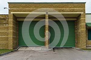 Large metal garage doors. Modern automatic garage door. Closed roller gates. Safe storage of the car