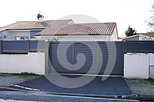 Large metal gate grey fence on suburb street house