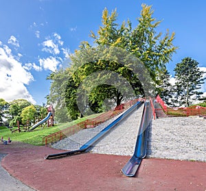 Large metal slides on top of a small hill at the entrance to Duthie Park, Aberdeen