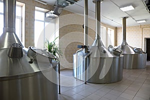 Large metal tanks for brewing beer in a beer factory