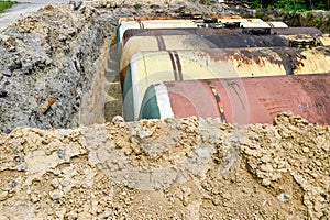 Large metal tanks are buried in the ground in the production war